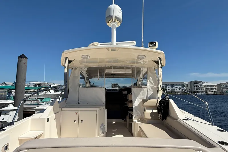  Yacht Photos Pics 2013 Pursuit SC 365i Sport Coupe docked at marina under clear blue sky.