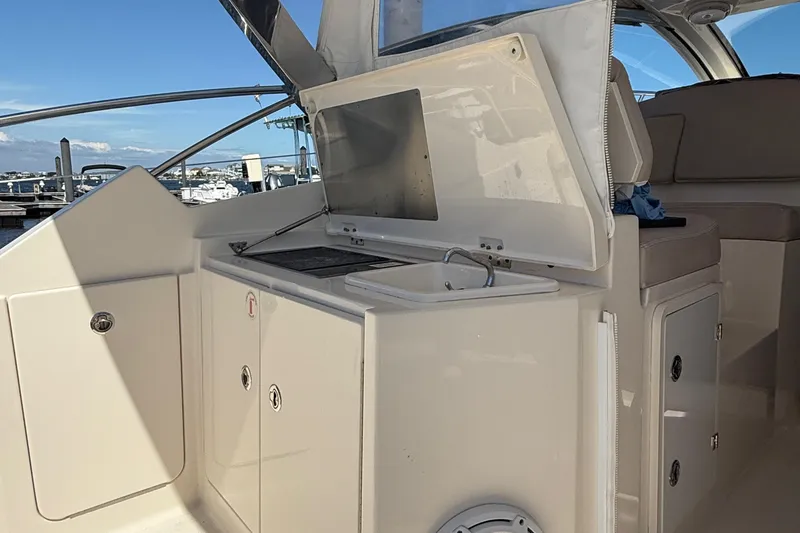  Yacht Photos Pics 2013 Pursuit SC 365i Sport Coupe boat interior with kitchenette and seating area.