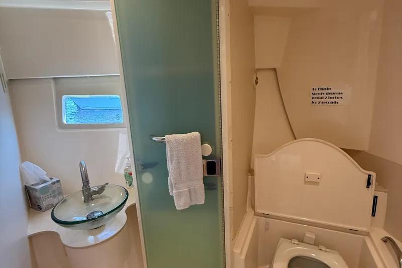  Yacht Photos Pics Bathroom interior of 2013 Pursuit SC 365i Sport Coupe with glass sink and toilet.