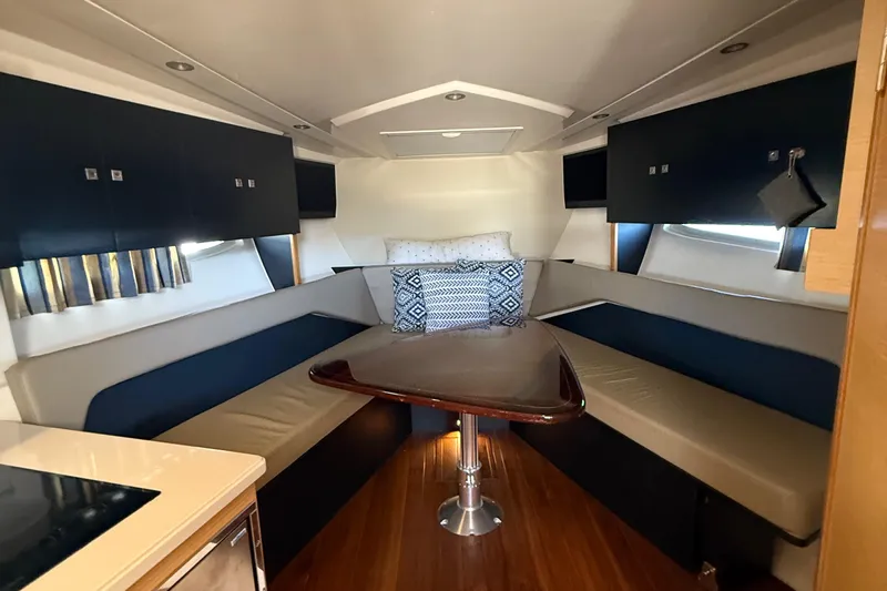  Yacht Photos Pics 2013 Pursuit SC 365i Sport Coupe interior with cozy seating and elegant table.