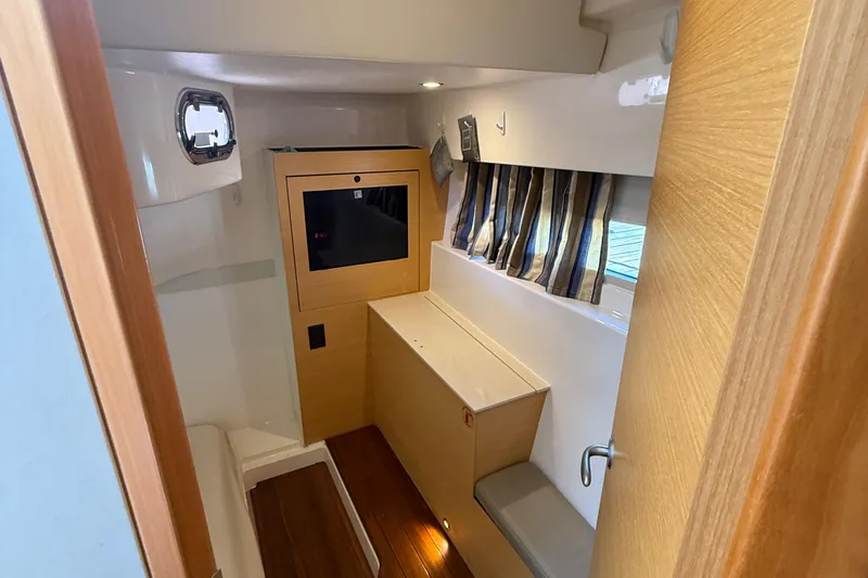  Yacht Photos Pics Interior of 2013 Pursuit SC 365i Sport Coupe with wood accents and striped curtains.