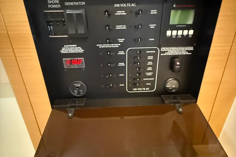  Yacht Photos Pics Control panel of a 2013 Pursuit SC 365i Sport Coupe, featuring various electrical switches.