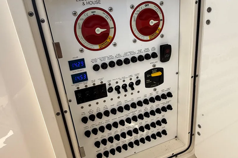  Yacht Photos Pics Electrical control panel of 2013 Pursuit SC 365i Sport Coupe boat, featuring switches and digital displays.