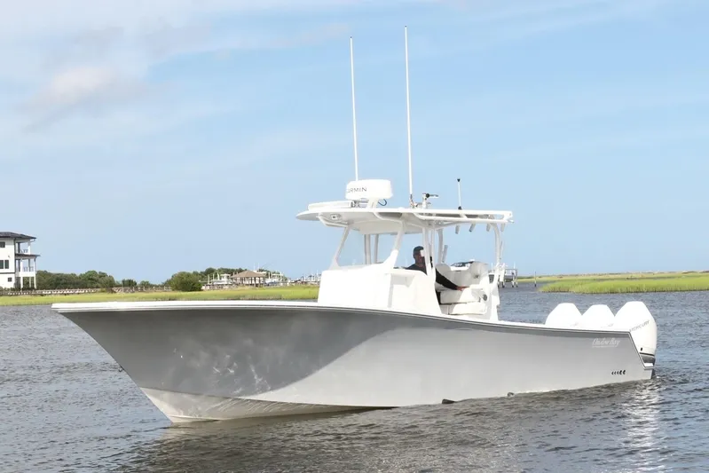  Yacht Photos Pics 2022 Onslow Bay 33 boat cruising on a calm waterway under a clear blue sky.