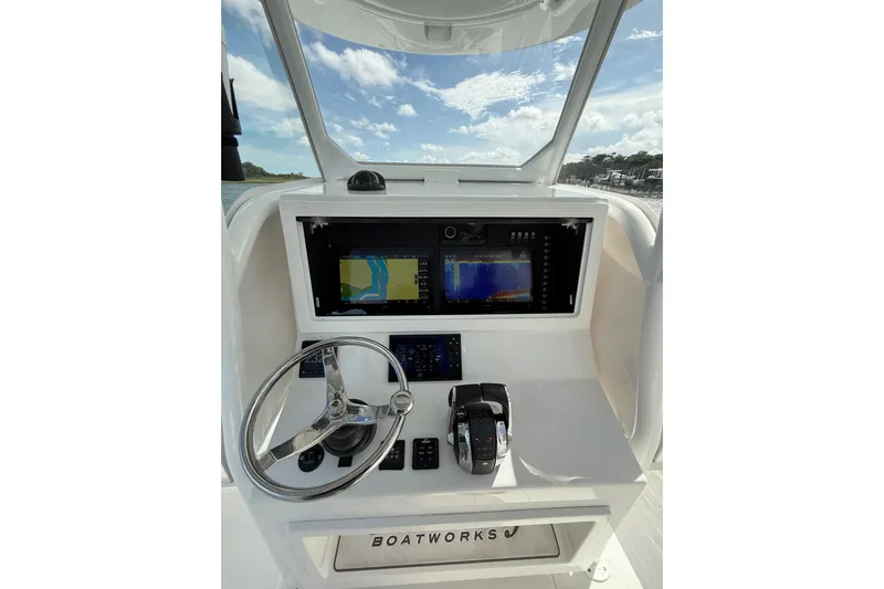  Yacht Photos Pics 2022 Onslow Bay 33 boat dashboard with navigation screens and steering wheel.