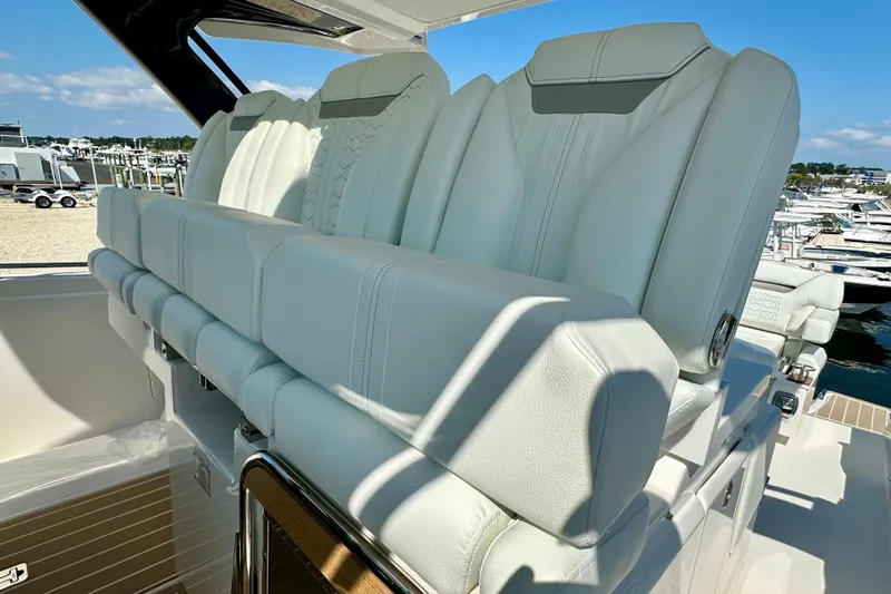  Yacht Photos Pics 2026 Tiara Yachts 34 LS boat with luxurious white leather seating, docked at a marina.