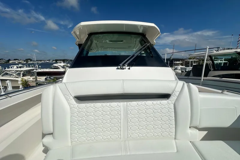  Yacht Photos Pics 2026 Tiara Yachts 34 LS boat with white seating and sleek design in marina setting.