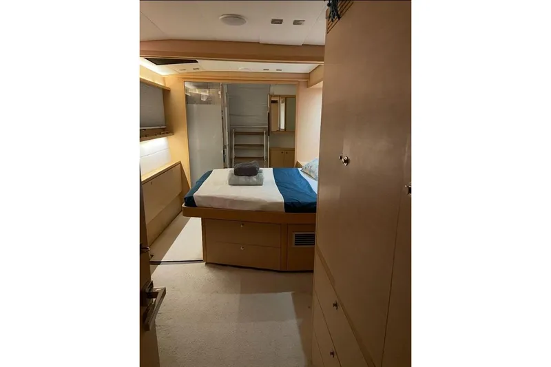 Somni Yacht Photos Pics Interior cabin of 2013 Lagoon 560 S2 yacht, featuring a cozy bed and modern design.