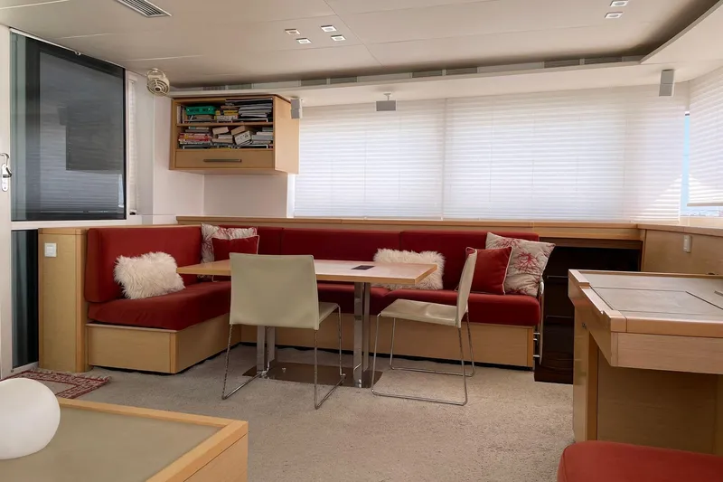 Somni Yacht Photos Pics Luxurious interior of 2013 Lagoon 560 S2 yacht with red seating and modern decor.