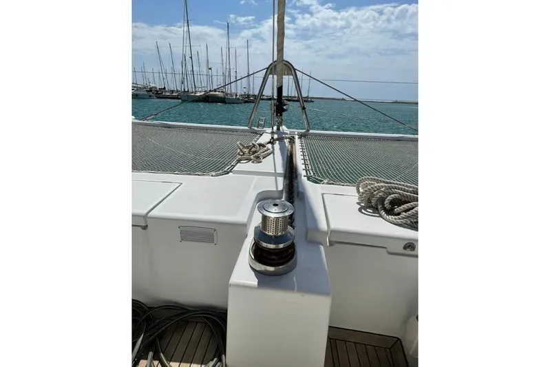 Somni Yacht Photos Pics 2013 Lagoon 560 S2 catamaran deck with winch and ropes, docked in marina.