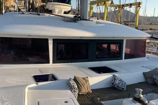 Somni Yacht Photos Pics 2013 Lagoon 560 S2 catamaran with spacious deck and modern design in marina setting.