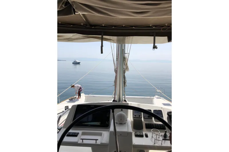 Somni Yacht Photos Pics Cockpit view of 2014 Lagoon 560 S2 yacht on calm sea.