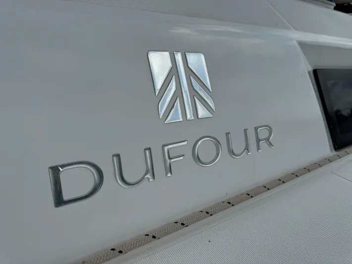 Pura Vida Yacht Photos Pics Dufour 530 yacht logo on white surface, 2022 model.