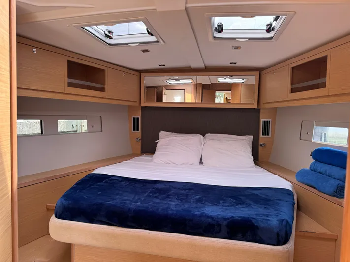 Pura Vida Yacht Photos Pics Luxurious cabin interior of 2022 Dufour 530 yacht with cozy bed and modern design.
