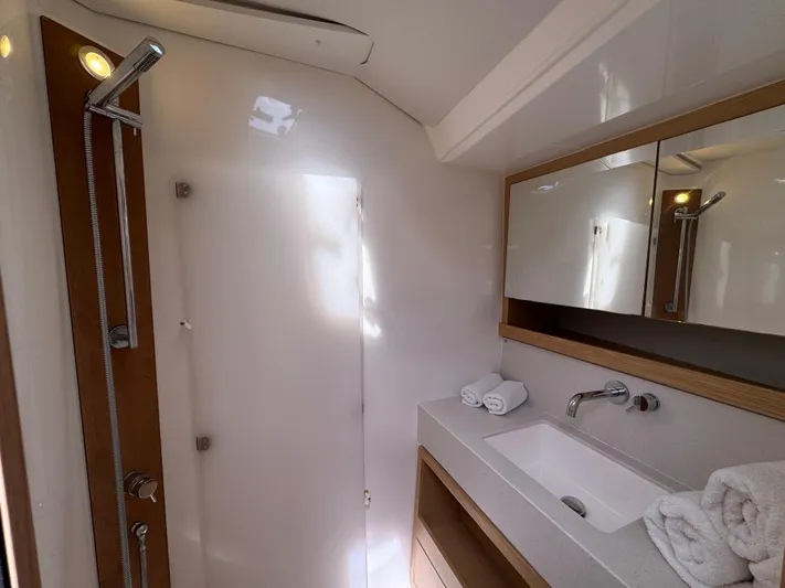 Pura Vida Yacht Photos Pics Modern bathroom in 2022 Dufour 530 yacht, featuring sleek shower and elegant vanity.
