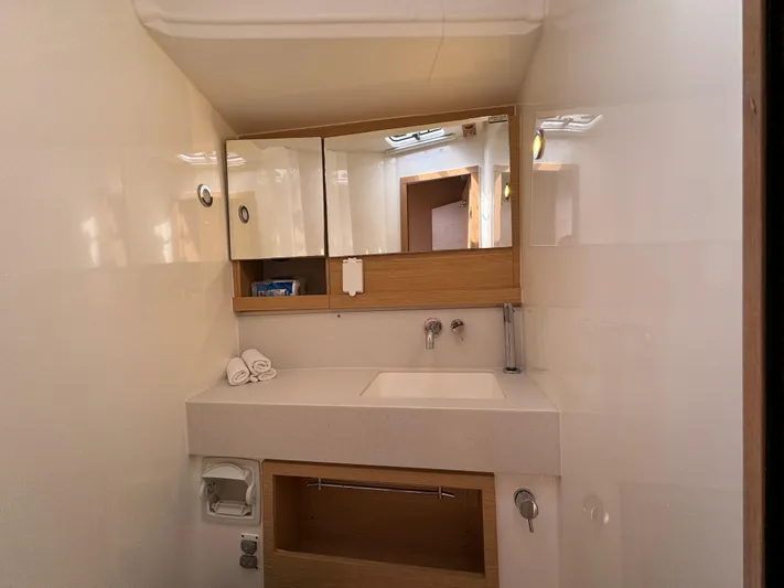 Pura Vida Yacht Photos Pics Modern bathroom interior on a 2022 Dufour 530 yacht, featuring sleek design and wooden accents.