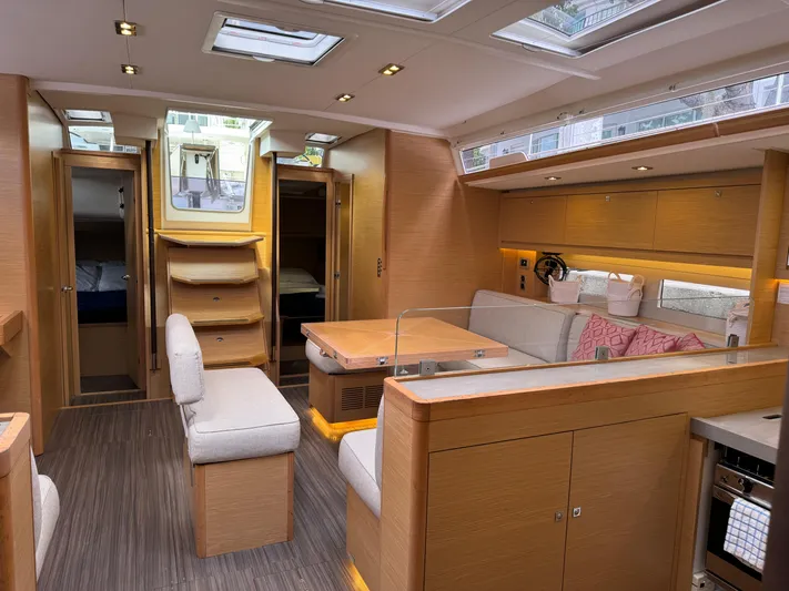 Pura Vida Yacht Photos Pics Luxurious interior of 2022 Dufour 530 yacht with modern furnishings and ample natural light.