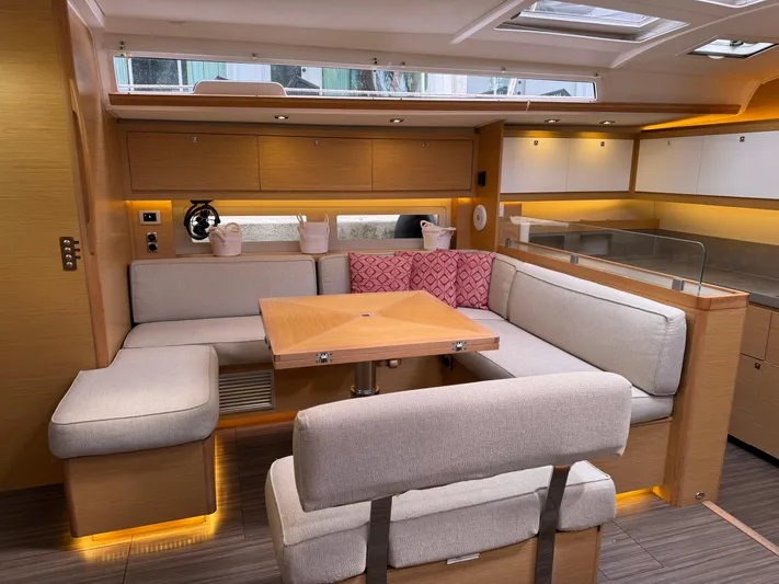 Pura Vida Yacht Photos Pics Luxurious interior of 2022 Dufour 530 yacht with modern seating and wooden accents.