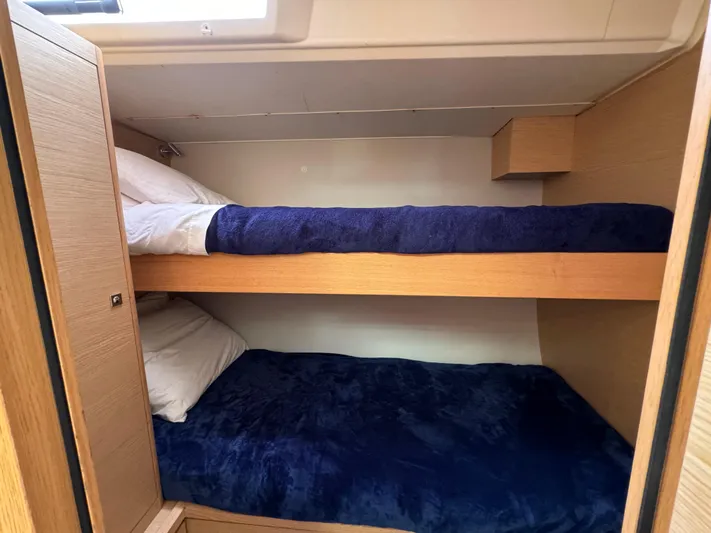 Pura Vida Yacht Photos Pics Bunk beds in 2022 Dufour 530 yacht cabin with blue bedding.