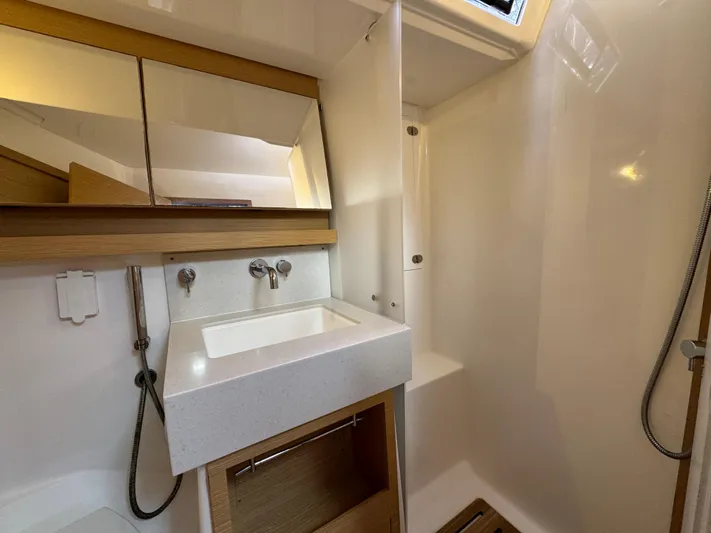 Pura Vida Yacht Photos Pics Modern bathroom in 2022 Dufour 530 yacht with sleek sink and shower area.