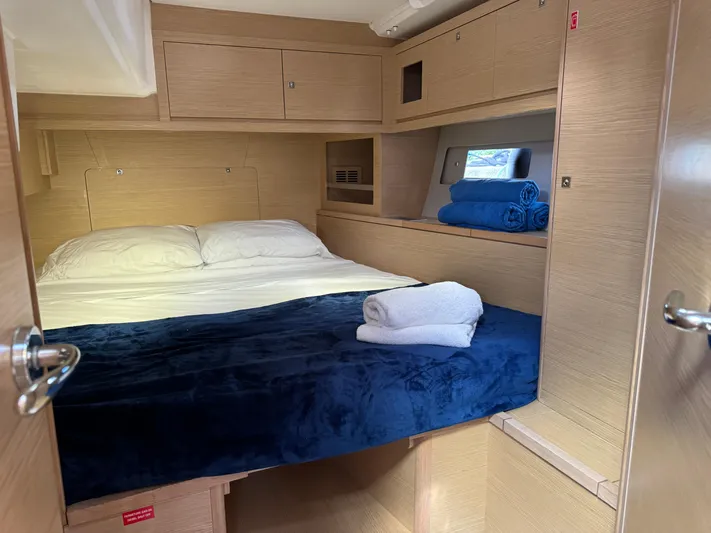Pura Vida Yacht Photos Pics Cozy cabin interior of 2022 Dufour 530 yacht with bed and storage.
