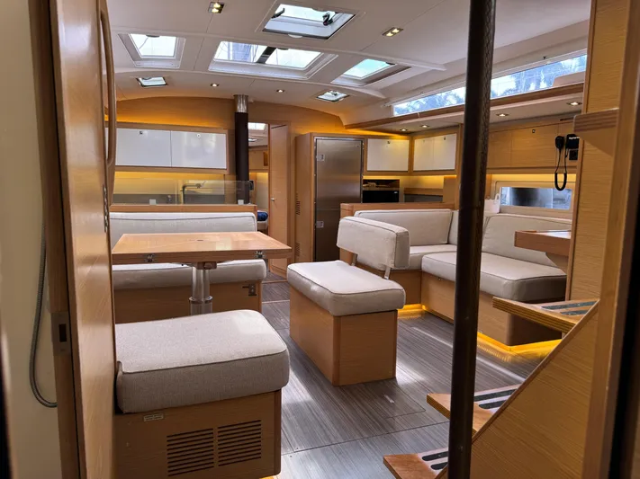 Pura Vida Yacht Photos Pics Luxurious interior of 2022 Dufour 530 yacht with modern seating and wooden finishes.