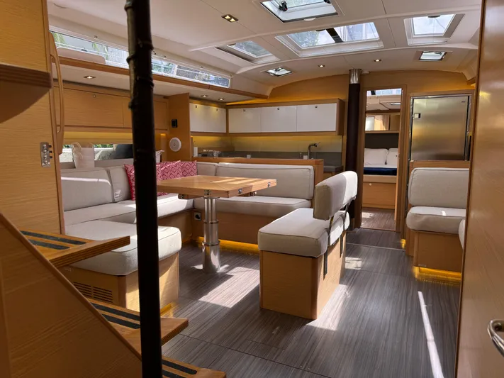 Pura Vida Yacht Photos Pics Luxurious interior of 2022 Dufour 530 yacht with modern seating and skylights.