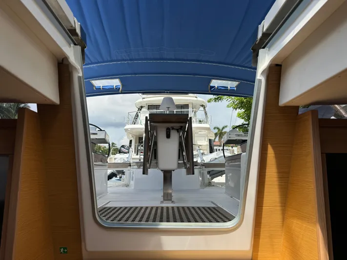 Pura Vida Yacht Photos Pics Interior view of a 2022 Dufour 530 yacht with blue canopy and outdoor seating.