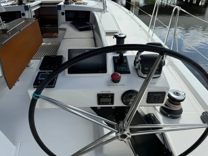 Pura Vida Yacht Photos Pics Steering wheel and controls of a 2022 Dufour 530 sailboat cockpit.