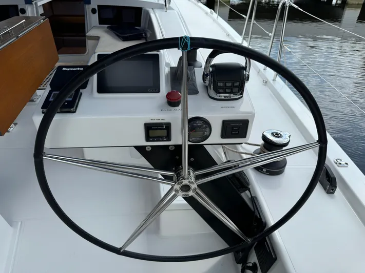 Pura Vida Yacht Photos Pics Steering wheel and controls of a 2022 Dufour 530 sailboat cockpit.