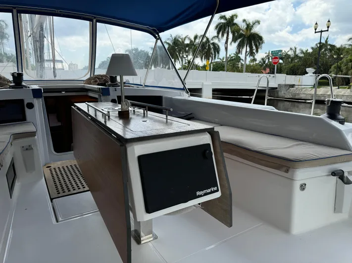 Pura Vida Yacht Photos Pics Dufour 530 sailboat cockpit with table, cushions, and canopy, 2022 model.