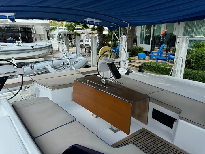 Pura Vida Yacht Photos Pics Spacious cockpit of 2022 Dufour 530 yacht with blue canopy and comfortable seating.