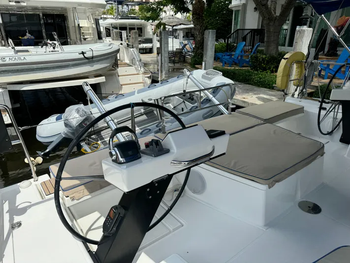 Pura Vida Yacht Photos Pics Dufour 530 sailboat cockpit with steering wheel, docked near other boats, 2022 model.