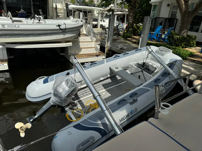 Pura Vida Yacht Photos Pics Inflatable boat docked near a Dufour 530 yacht, 2022 model, in a marina setting.