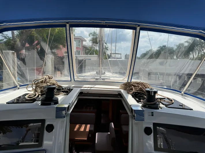 Pura Vida Yacht Photos Pics Dufour 530 sailboat cockpit view, ropes and winches, 2022 model, marina background.