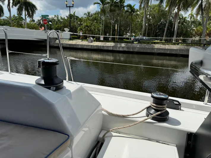 Pura Vida Yacht Photos Pics Dufour 530 sailboat deck view near canal with palm trees, 2022 model.