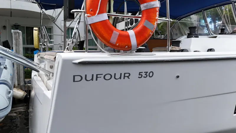 Pura Vida Yacht Photos Pics Dufour 530 sailboat, 2022 model, docked with visible lifebuoy and deck details.