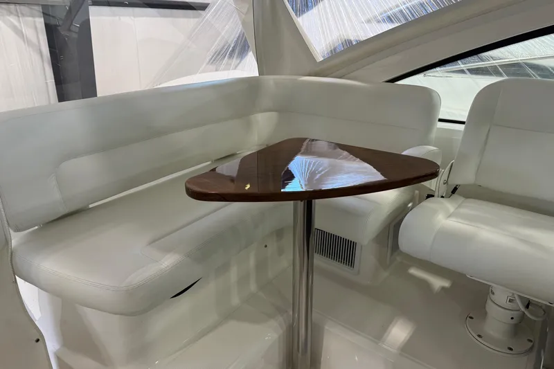  Yacht Photos Pics 2023 Tiara Yachts 43 Open interior with white seating and wooden table.