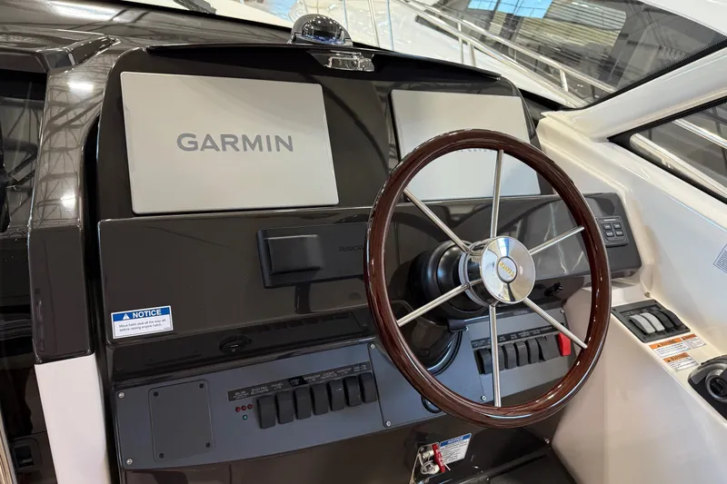  Yacht Photos Pics 2023 Tiara Yachts 43 Open helm with Garmin navigation system and wooden steering wheel.