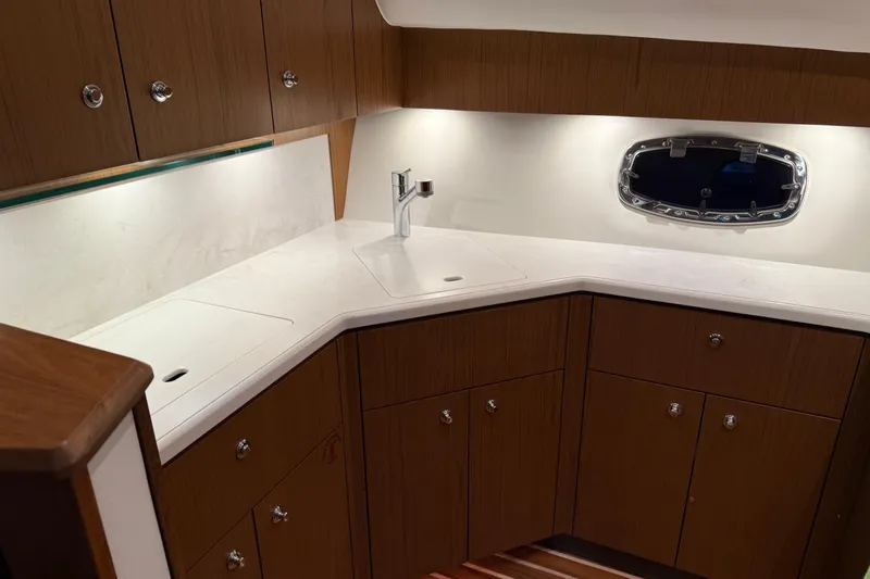  Yacht Photos Pics Luxurious 2023 Tiara Yachts 43 Open galley with sleek wood cabinetry and modern fixtures.