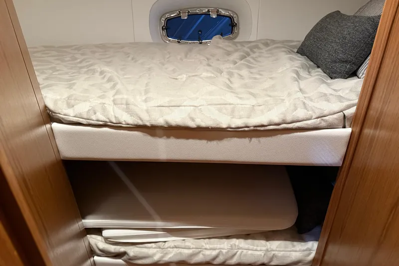  Yacht Photos Pics 2023 Tiara Yachts 43 Open cabin interior with cozy bedding and porthole.