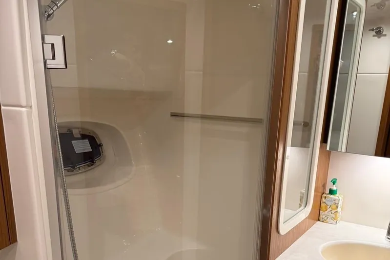  Yacht Photos Pics 2023 Tiara Yachts 43 Open bathroom with shower and sink area.