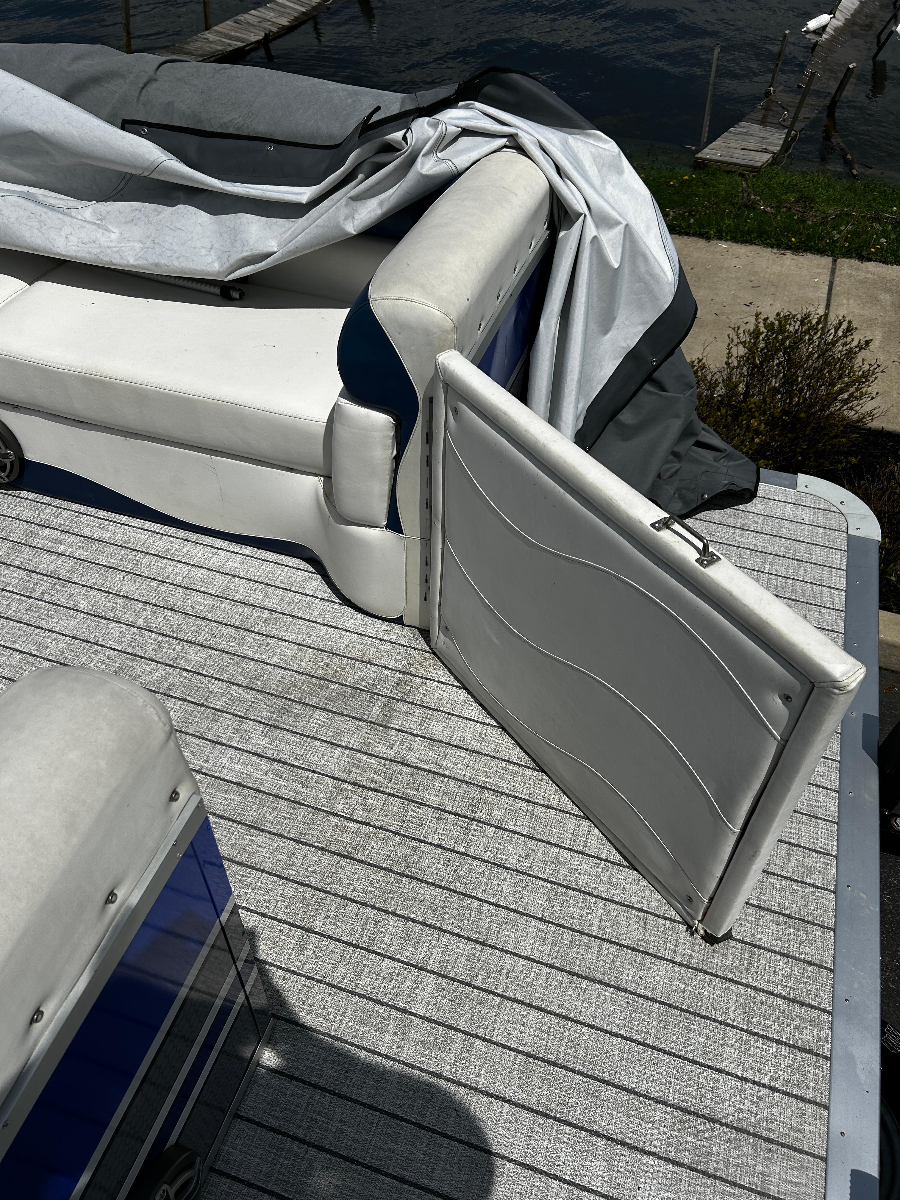 2005 Evolution 26 boat interior with white seating and open compartment.
