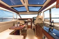 Luxurious interior of 2018 Nimbus 365 yacht with panoramic windows and elegant seating area.