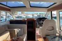 Interior of 2018 Nimbus 365 yacht with helm, seating, and panoramic windows.