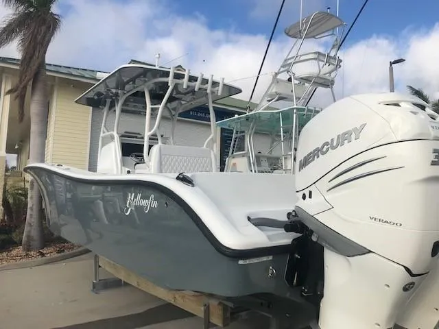  Yacht Photos Pics 2019 Yellowfin 34 Offshore boat with Mercury engine, docked under blue sky.