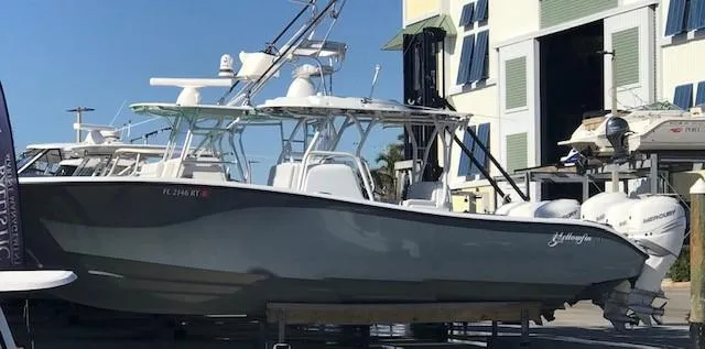  Yacht Photos Pics 2019 Yellowfin 34 Offshore boat docked with triple outboard engines.