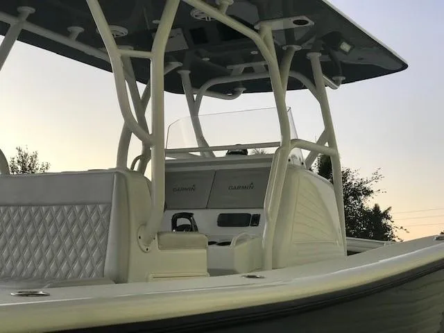  Yacht Photos Pics 2019 Yellowfin 34 Offshore boat interior with Garmin electronics and cushioned seating.