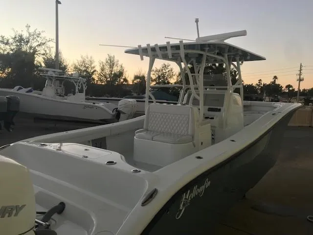  Yacht Photos Pics 2019 Yellowfin 34 Offshore boat at sunset, docked with trees in the background.