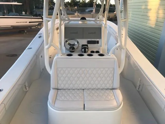 Yacht Photos Pics 2019 Yellowfin 34 Offshore boat interior with white seating and steering console.
